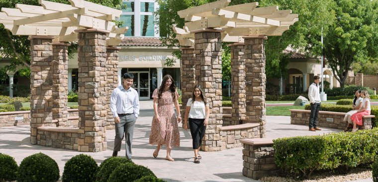 Students talking and walking on campus at WCBC