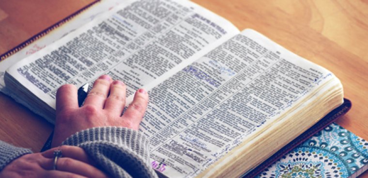 bible and ladies hand