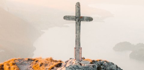 Cross on a hill with a cloudy background