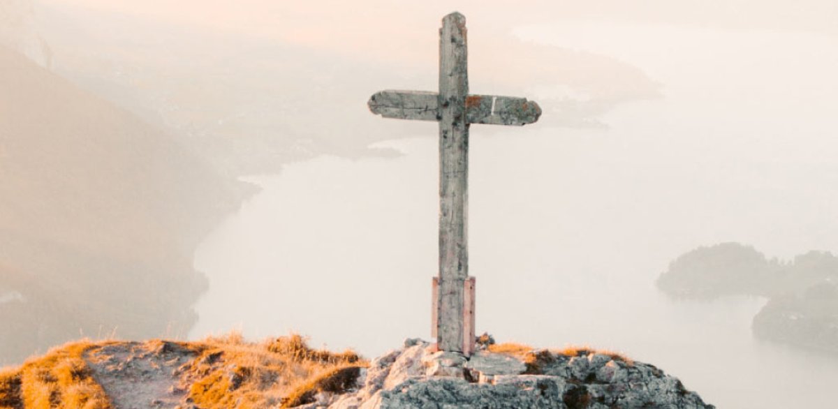 Cross on a hill with a cloudy background