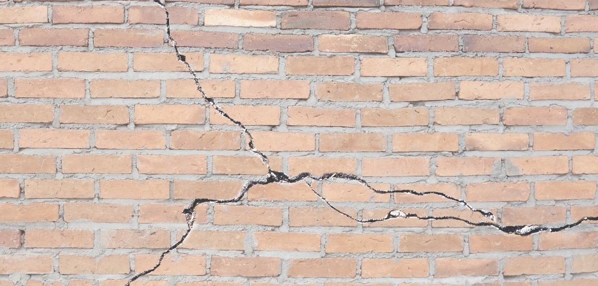 cracking brick wall